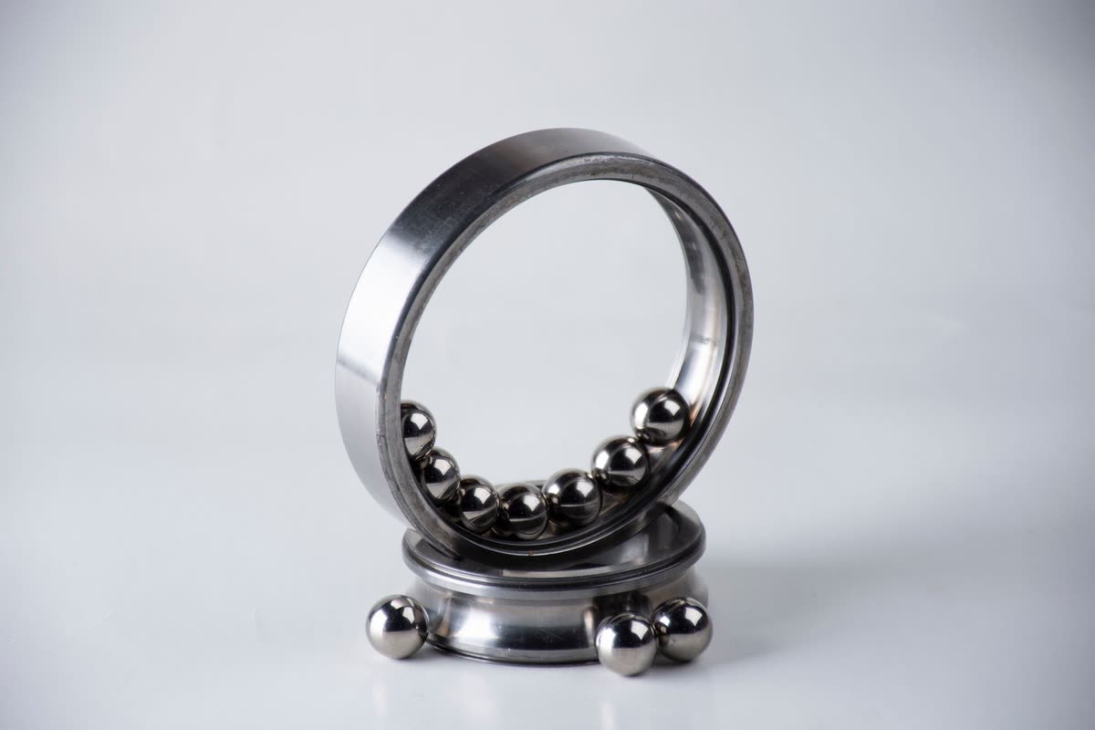 Deep groove ball bearing with loose steel balls on a white background