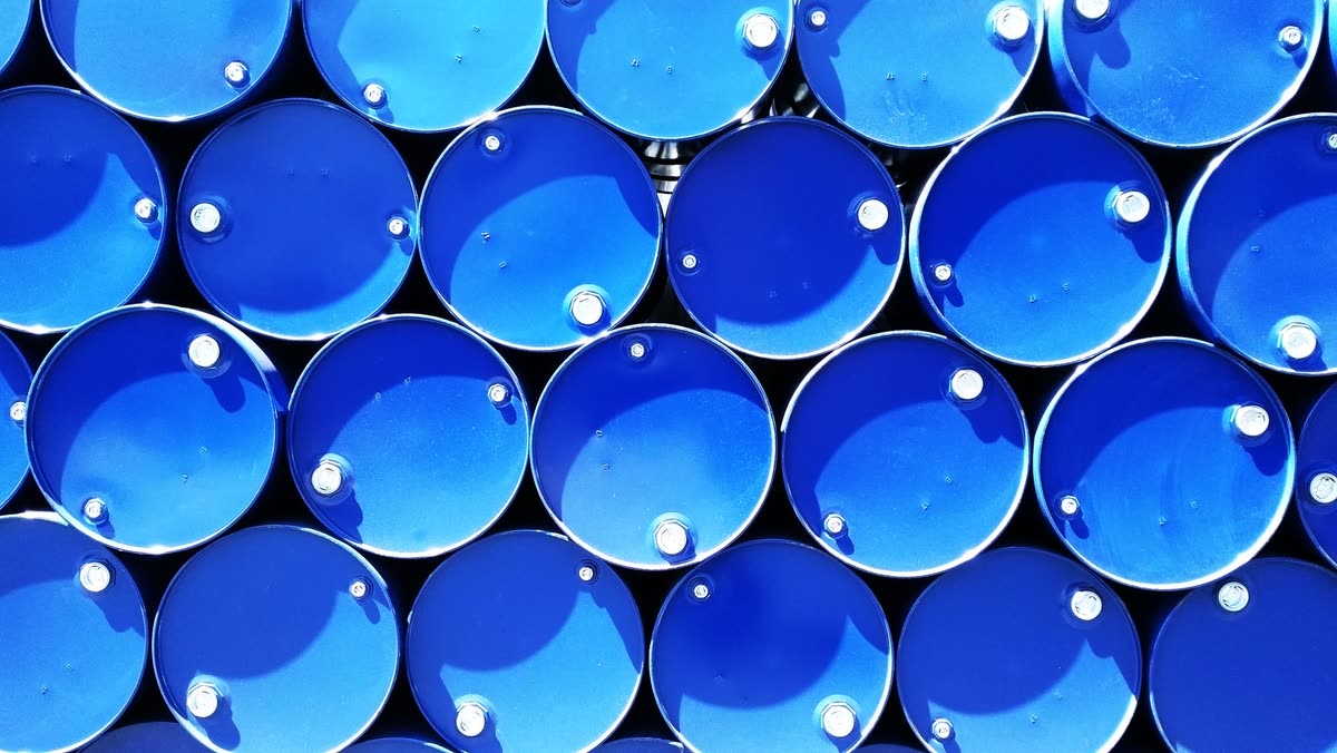 Stacked blue steel chemical drums seen from above